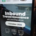 Official National Insurance Corporation sign announcing mandatory Tanzania travel insurance starting October 2026