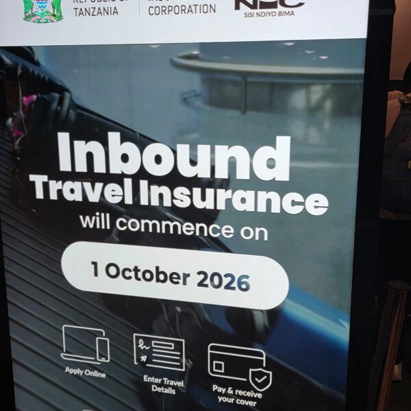 Official National Insurance Corporation sign announcing mandatory Tanzania travel insurance starting October 2026